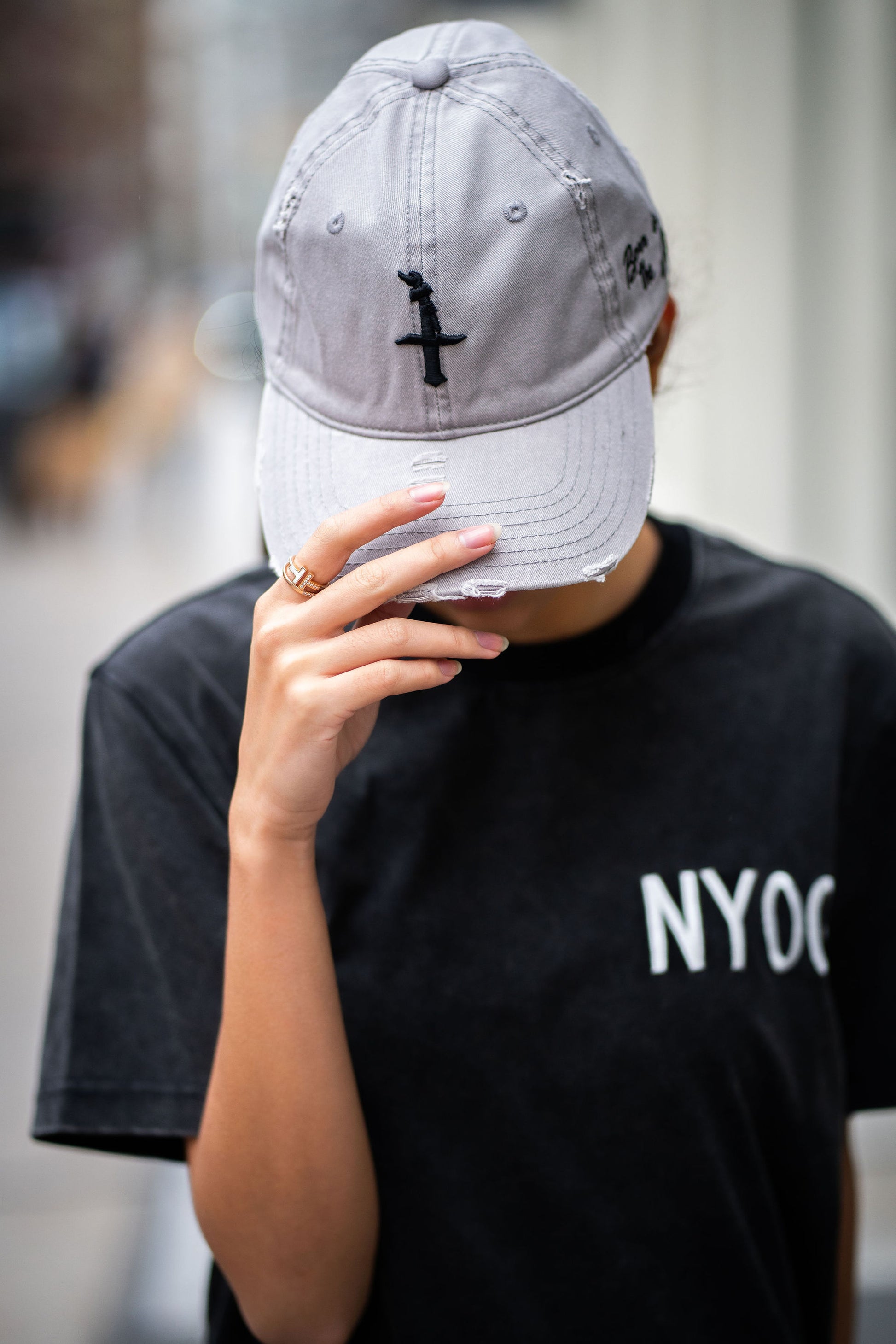 Gray distressed dad hat with BITA torch on center front in black embroidery and born in the apple text on left side hat in black embroidery.